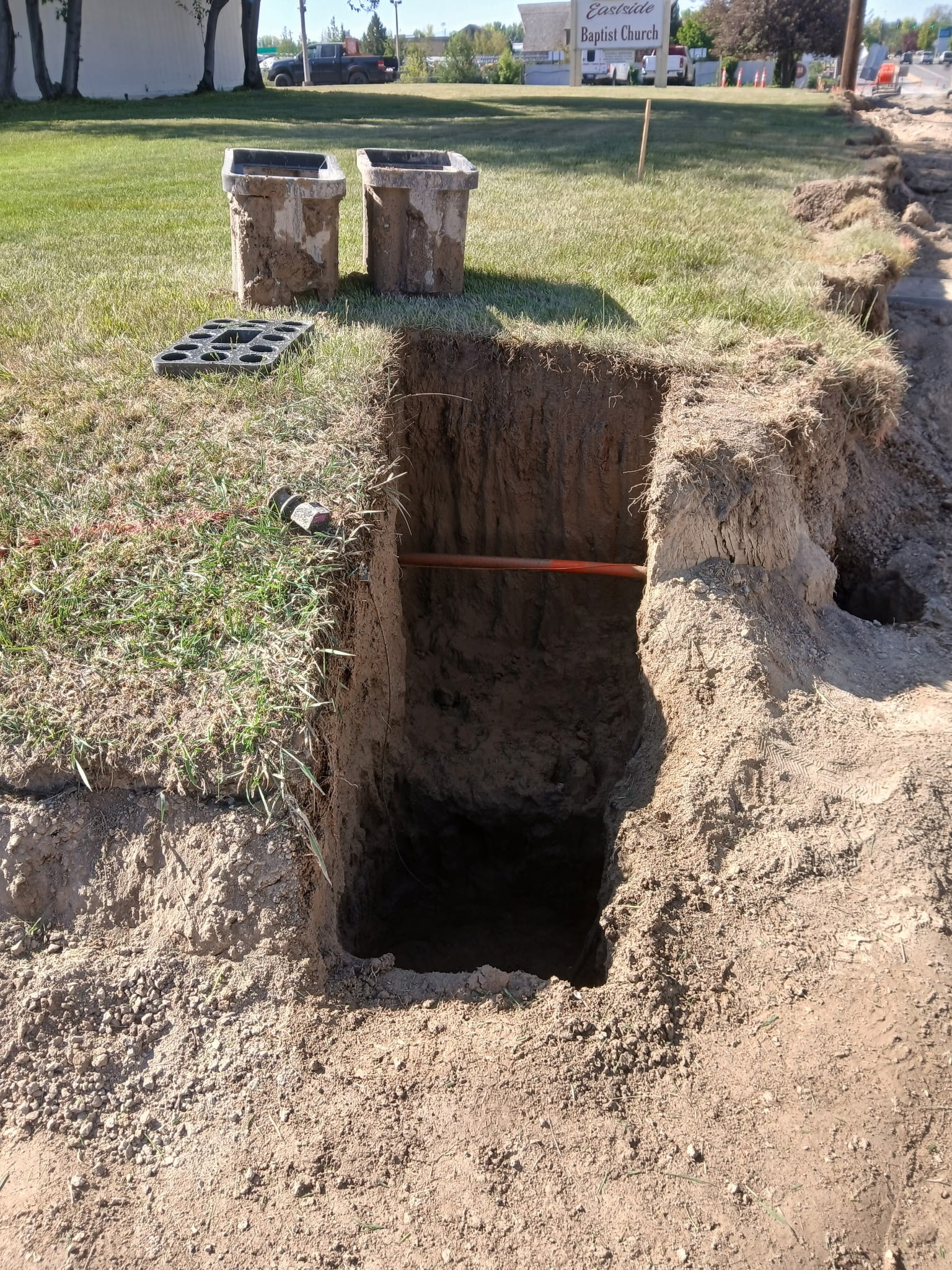 Deep utility excavation trench on Eastland Drive near Eastside Baptist Church