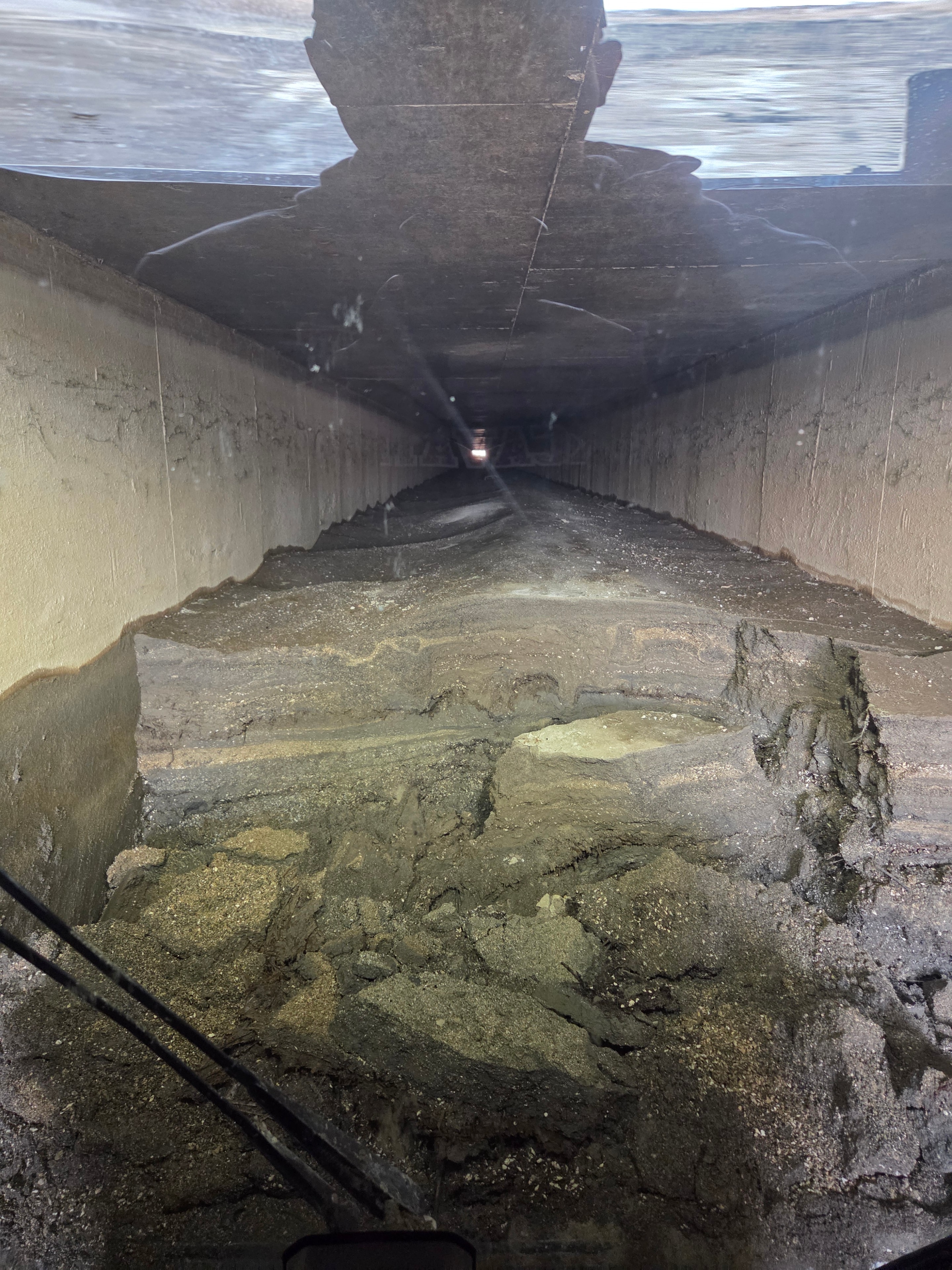 ITD siphon sediment buildup inside concrete tunnel